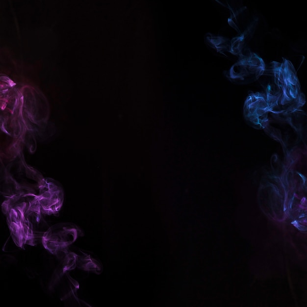 Foto gratuita efecto humo azul y púrpura sobre fondo negro