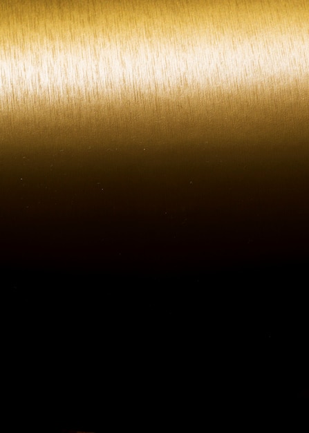 Foto gratuita oro textura fondo degradado vertical negro