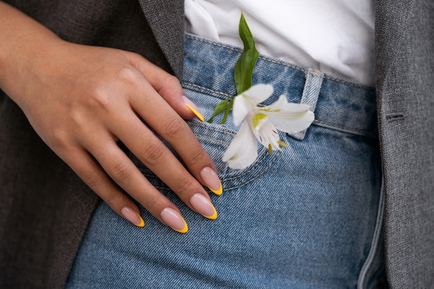 Foto gratuita mujer mostrando su arte de uñas en las uñas con flor
