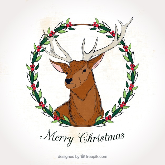 Free vector merry christmas hand drawn deer card with floral wreath