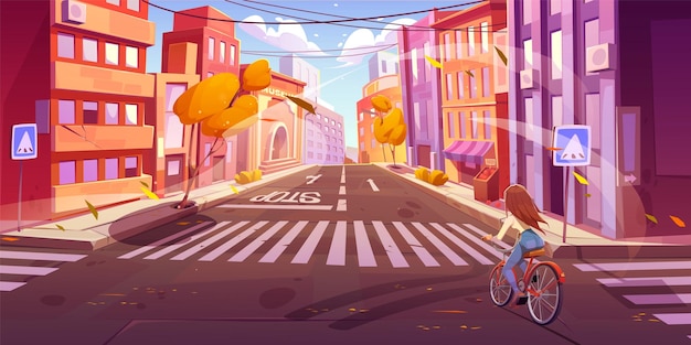 Молодая женщина на велосипеде по осенней городской улице