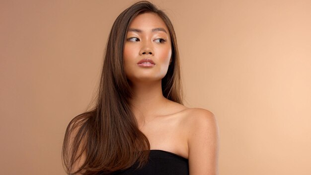 Thai asian model with natural makeup on beige background