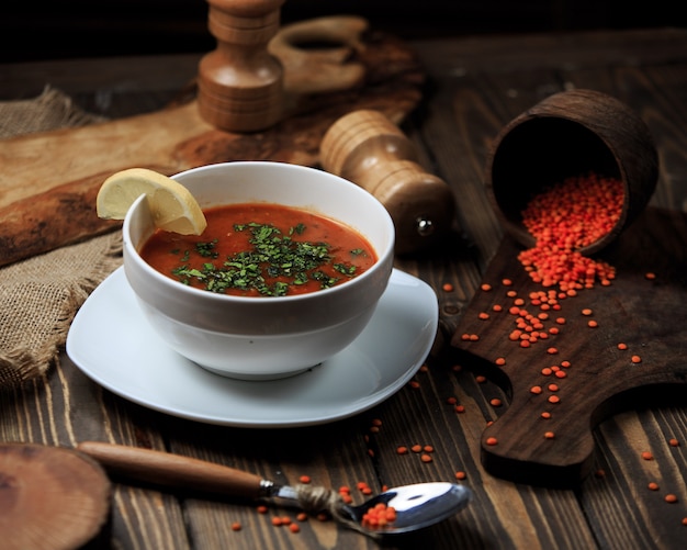Tomato soup in a bowl with lemon and spices