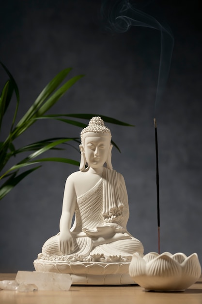 View of buddha statuette with incense