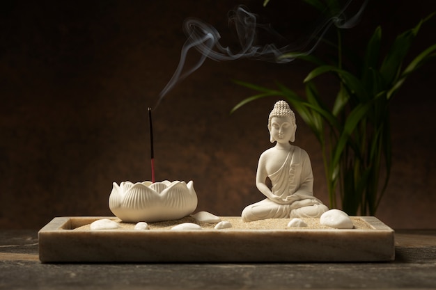 View of buddha statuette with incense