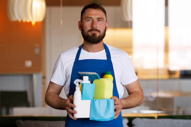 View of professional cleaning service person holding supplies
