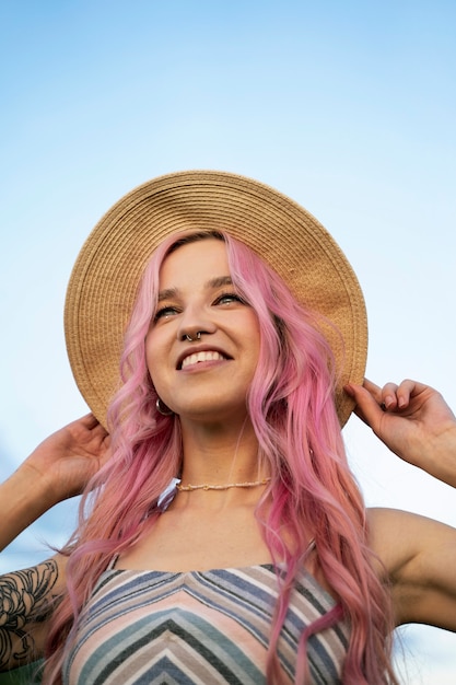 Free photo young woman with pink hair smiling