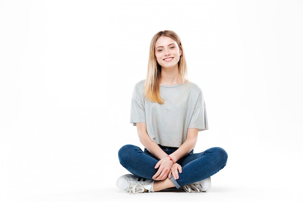 Free photo young woman sitting cross-legged isolated