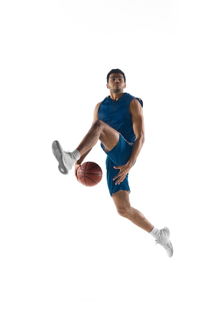 Free photo young arabian muscular basketball player in action, motion isolated on white