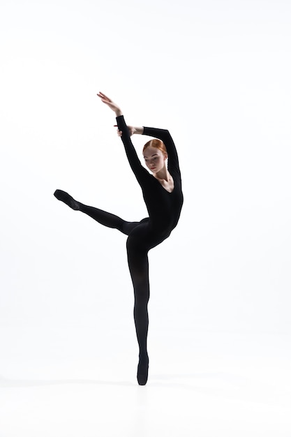 Free photo young and graceful ballet dancer in minimal black style isolated on white studio background.