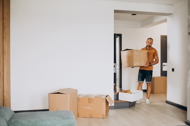 Free photo young man moving into new house
