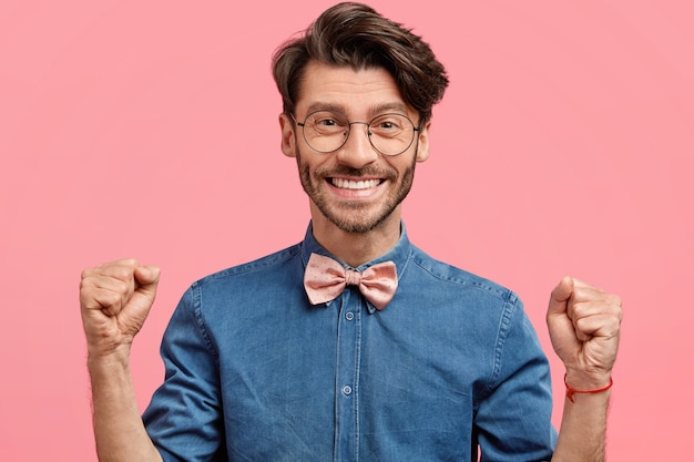 Free photo young man with round glasses and pink bowtie