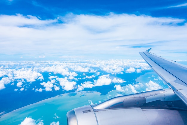 Aerial view of airplane wing with blue sky
