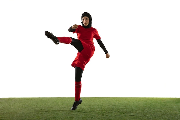 Free photo arabian female soccer player isolated on white studio wall