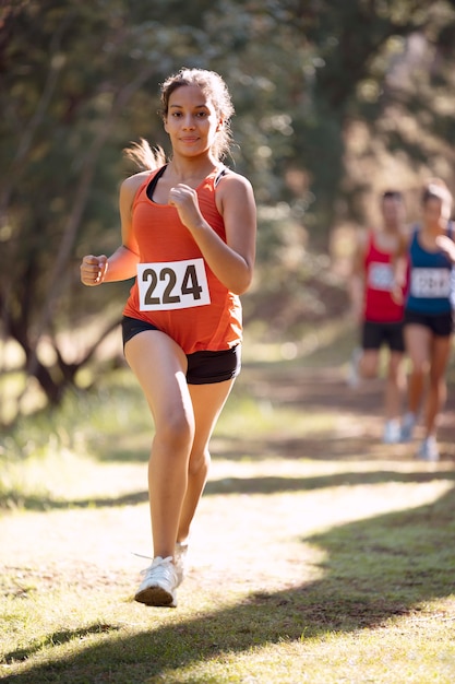 Free photo athletic woman participating in a cross country