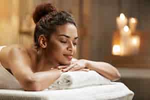 Free photo beautiful african woman resting relaxing in spa resort with closed eyes.