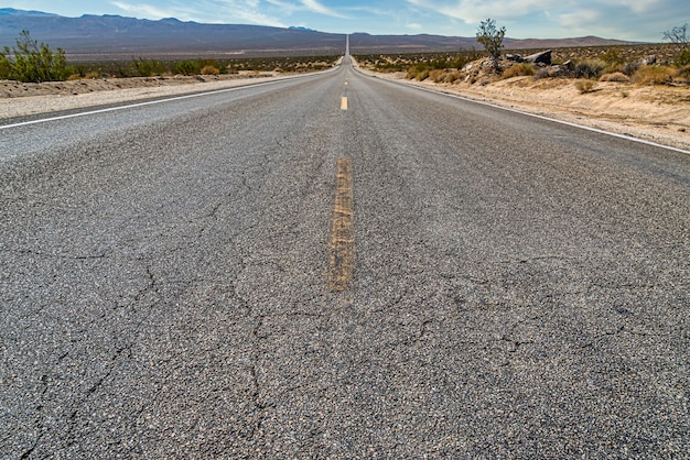 Бесплатное фото Красивый снимок длинной прямой бетонной дороги между пустынным полем