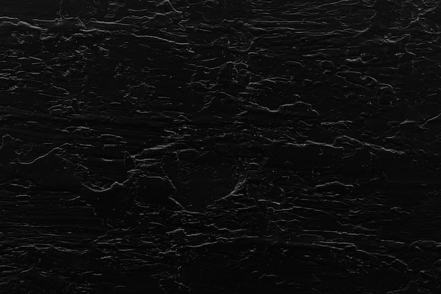 Free photo black cracked textured wall background