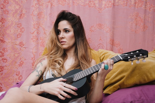 Free photo charming woman with ukulele