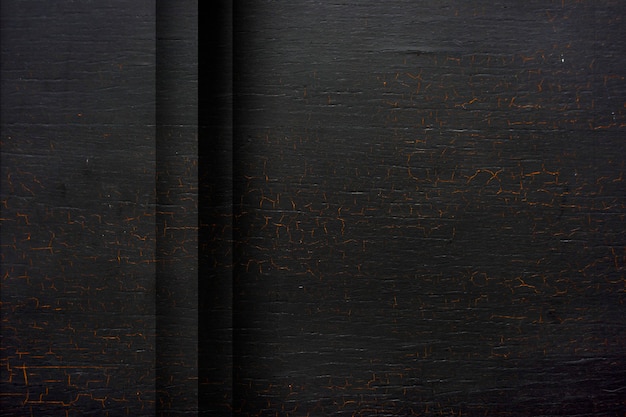 Free photo cracked black wooden textured background