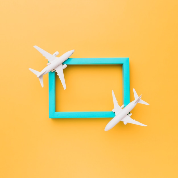 Free photo empty blue frame with small planes