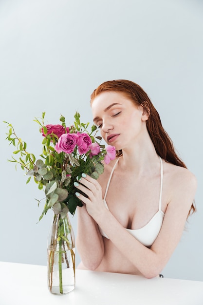Free photo fashion portrait of a young redheaded girl with eyes closed