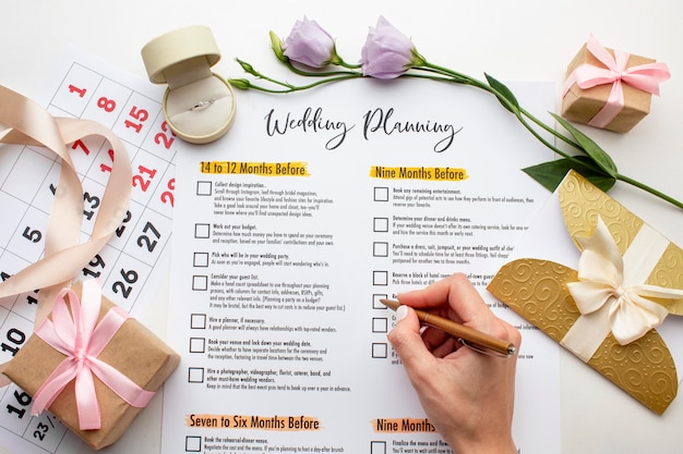 Free photo feminine hands writing on wedding planner