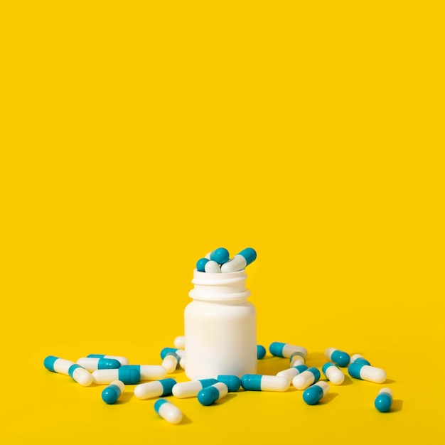 Free photo front view of container with pills and copy space