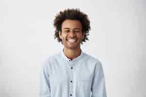 Free photo handsome unshaven young dark-skinned male laughing out loud