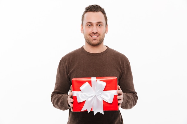 Free photo happy young man holding gift box surprise.