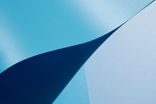 Free photo high view of blue curved sheets of paper