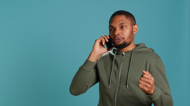 Free photo irked man fighting with friends during telephone call