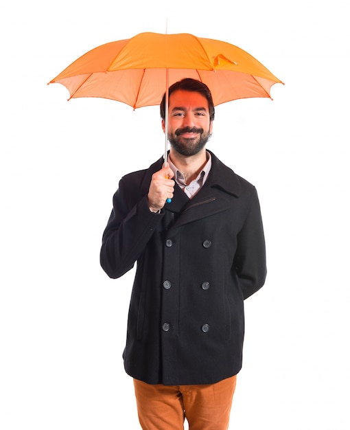 Free photo man holding an umbrella over white background