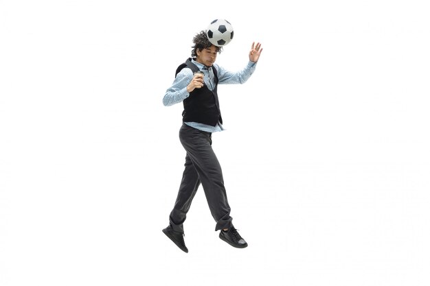 Человек в одежде офис, играя в футбол или футбол с мячом на пустое пространство. Необычно искать бизнесмена в движении, действии. Спорт, здоровый образ жизни.