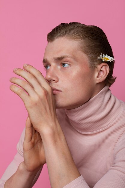 Man posing with flower side view