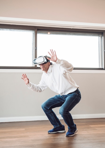 Free photo man pretending to touch while wearing virtual reality headset
