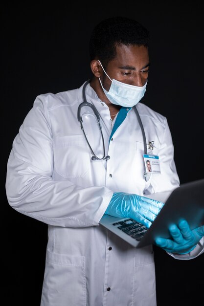 Medium shot doctor with laptop