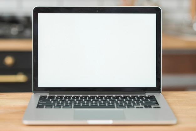 Free photo modern laptop with blank white screen on wooden table