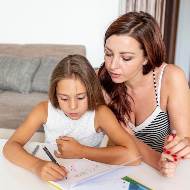 Mother helping with her daughter's homework