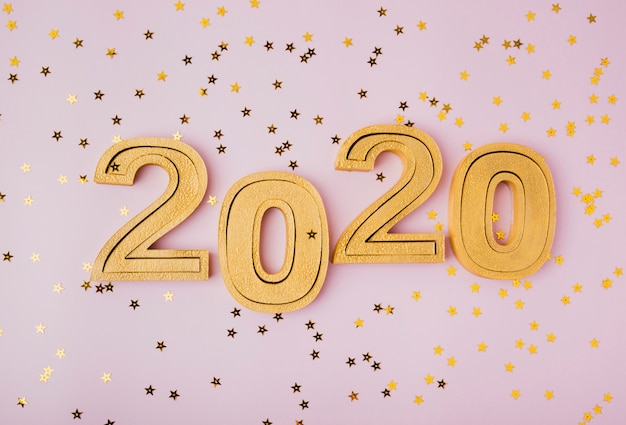 Free photo new year celebration 2020 and golden glitter stars