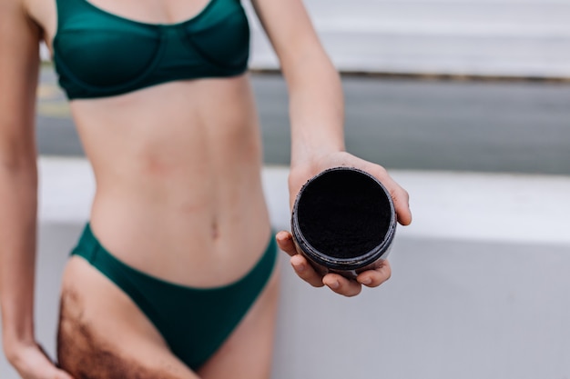 Free photo outdoor shot of woman with coffee body scrub.