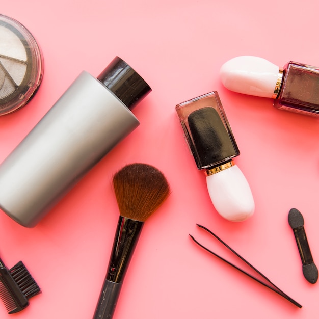 Free photo an overhead view of cosmetics makeup products on pink backdrop