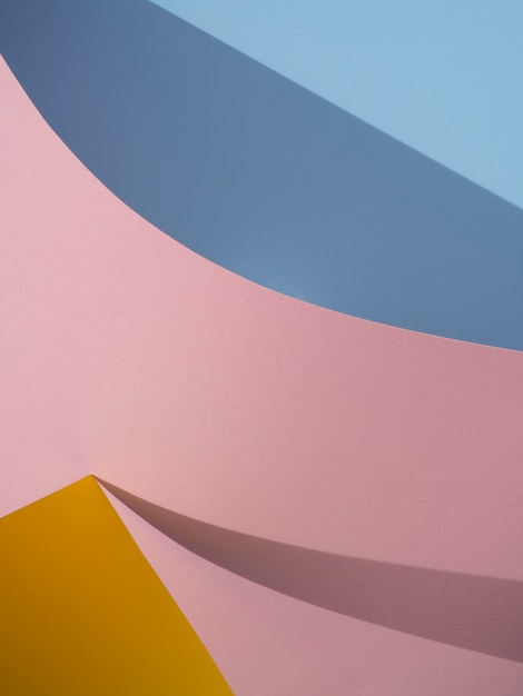 Free photo pink and blue abstract paper shapes with shadow