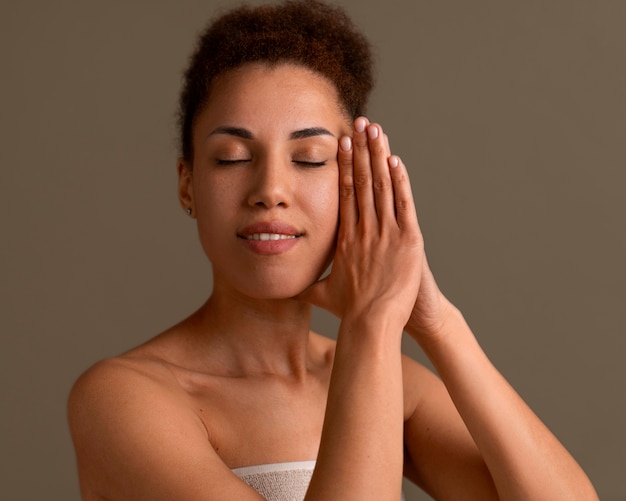 Free photo portrait of woman trying facial yoga massage to stay young