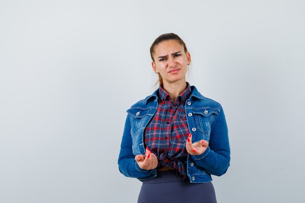 Free photo portrait of young lady showing clueless gesture in shirt, jacket and looking disappointed front view