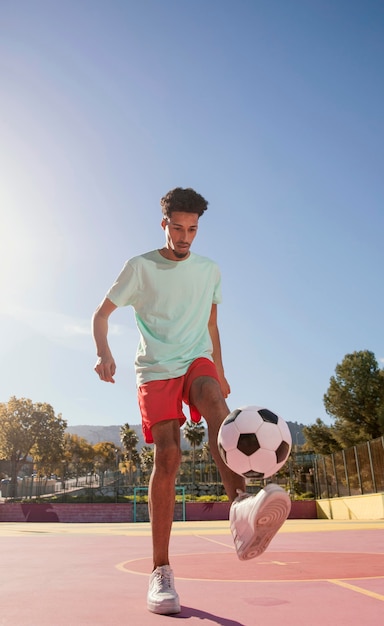 Portrait young man playing football