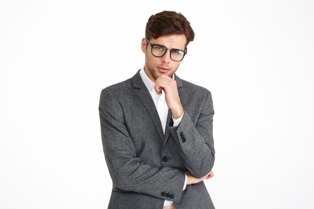 Free photo portrait of a young serious business man in eyeglasses