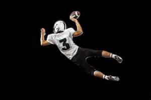 Free photo portrait of american football player in sports equipment isolated on black