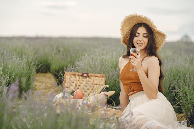 Free photo provence woman relaxing in lavender field. lady in a picnic.