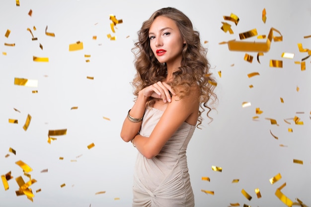 Бесплатное фото Красивая женщина празднует новый год в золотом конфетти